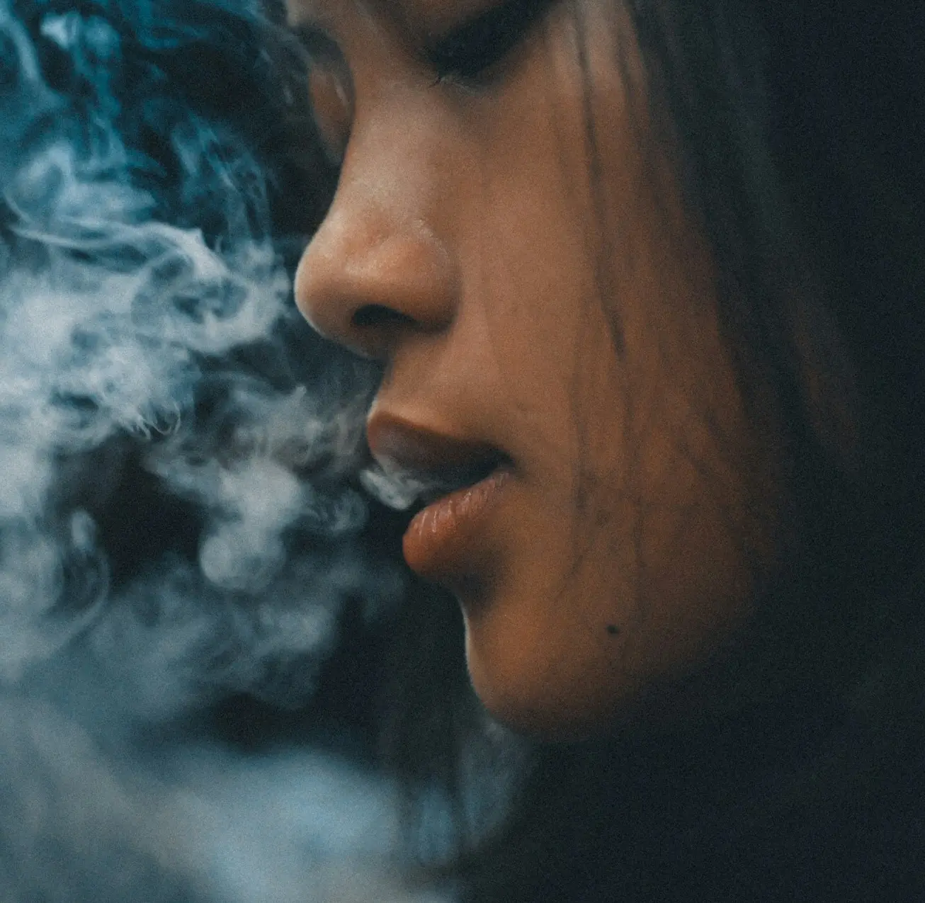 woman with blue and white smoke